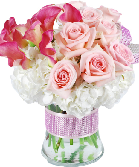 Light pink and hot pink flowers in a glass vase accented by pink bling.