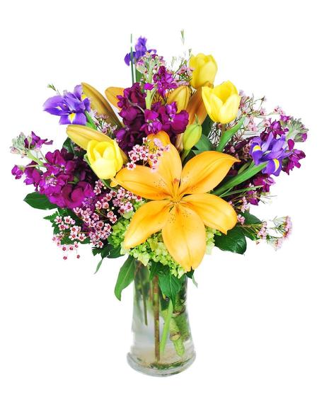 Yellow and purple flowers in a clear glass vase.