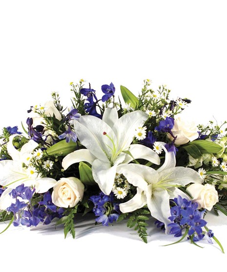 Hanukkah centerpiece with white lilies, roses, blue delphinium and monte casino