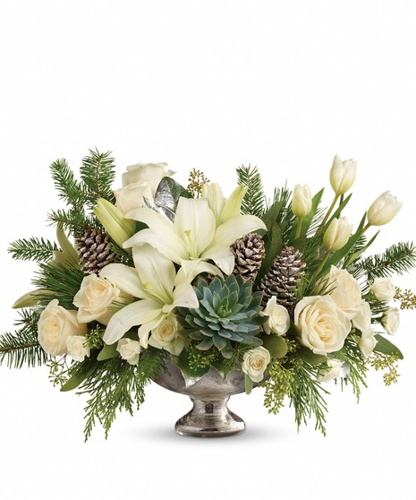 Mercury glass bowl of winter greenery and white blooms. 